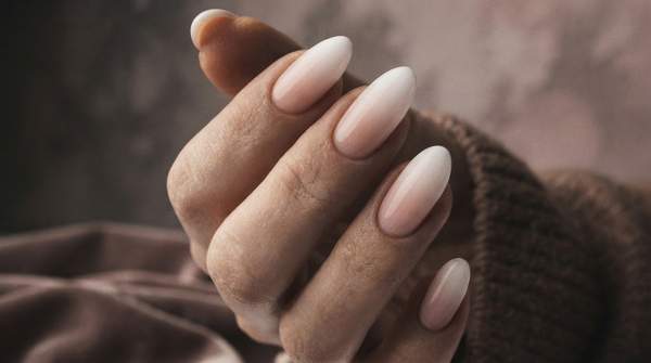 Editorial illustration for How Dip Powder Nails Work: The Three-Chemical Reaction That Builds a Chip-Resistant Manicure